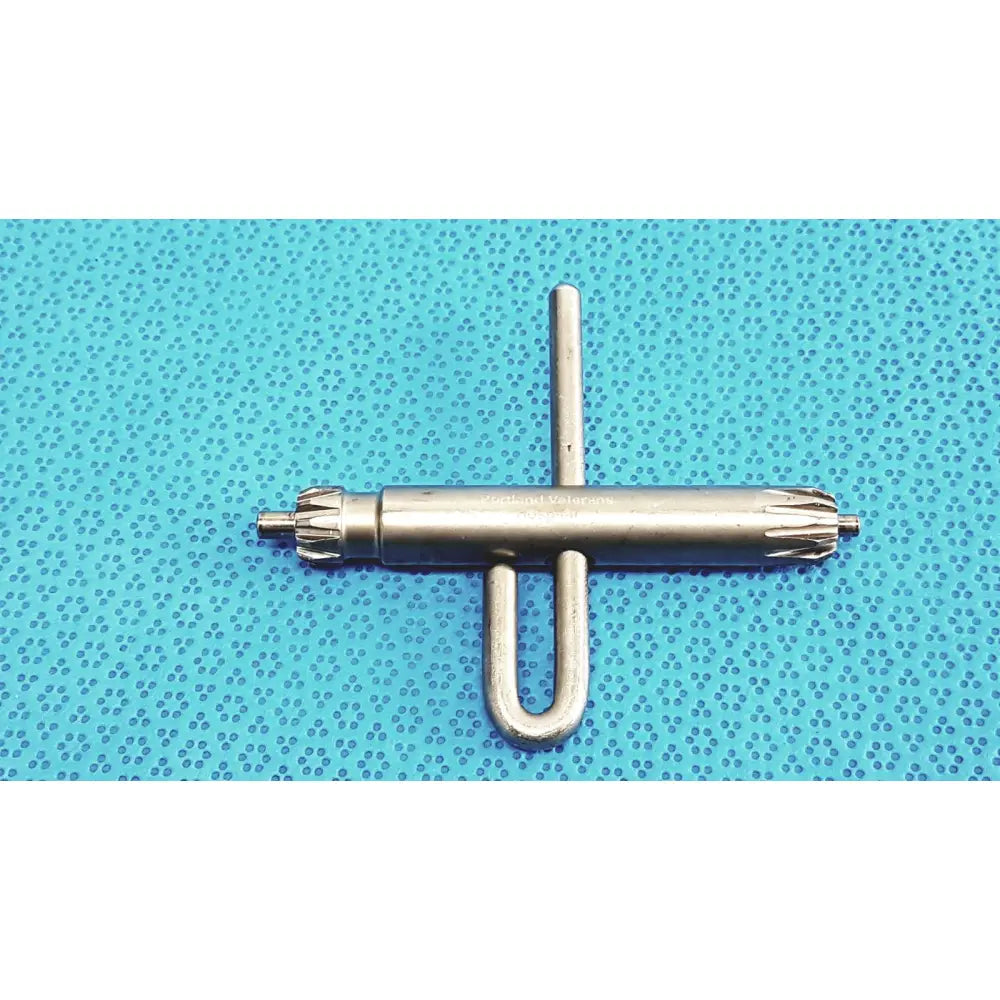 Silver orthopedic drill chuck key with u-shaped handle and toothed ends compatible with 3.8mm and 3.2mm pin holes