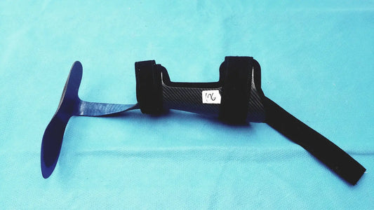 Black carbon fiber orthotic foot drop brace left foot with adjustable straps and central support structure