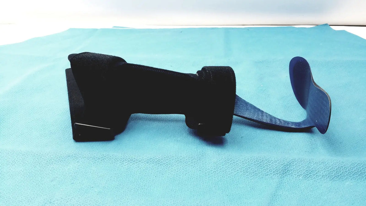 Black orthopedic foot drop brace left foot with adjustable strap and contoured design for effective support