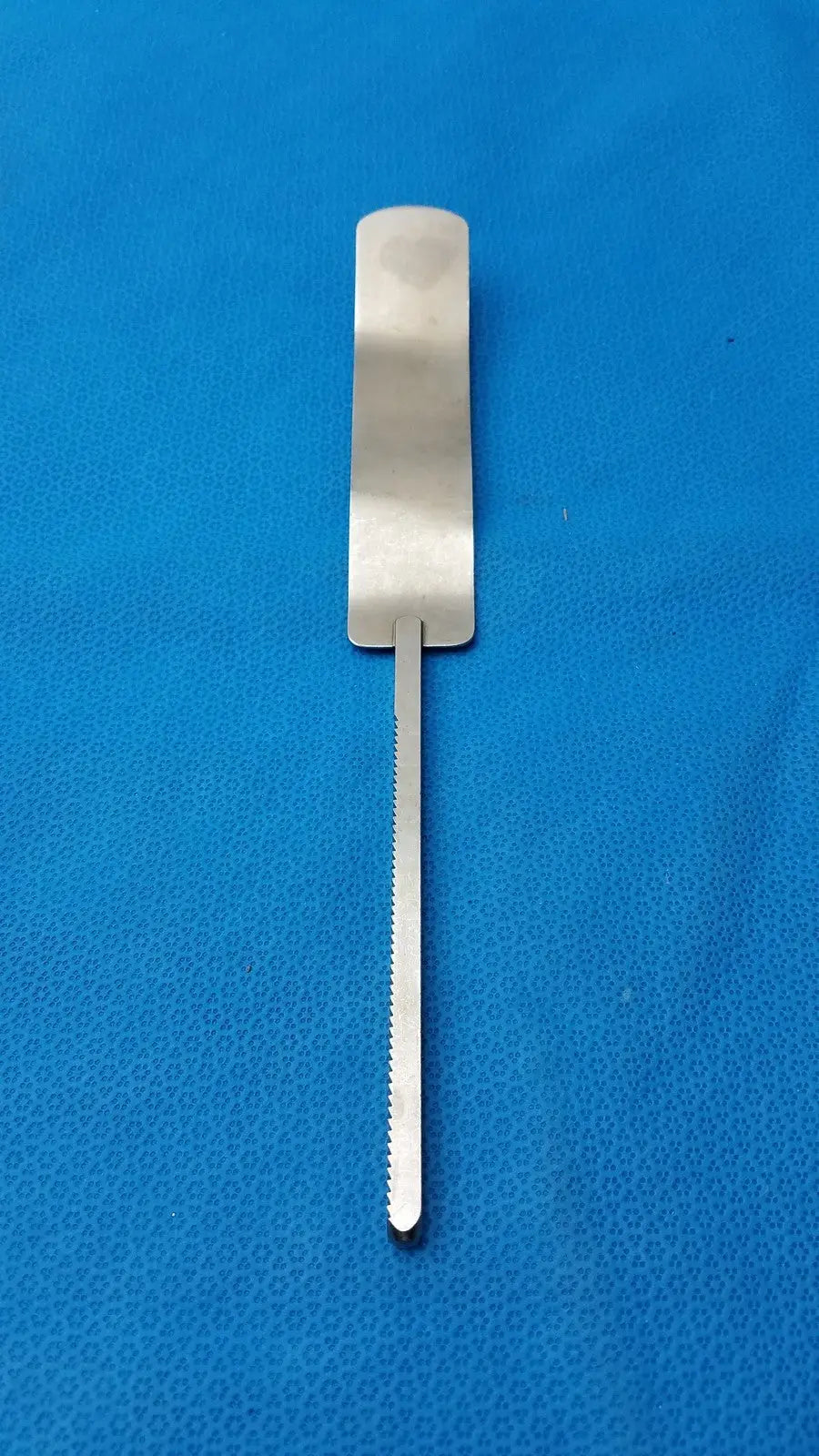 Silver osteotome stainless steel surgical instrument with flat handle and serrated blade for precise bone cutting