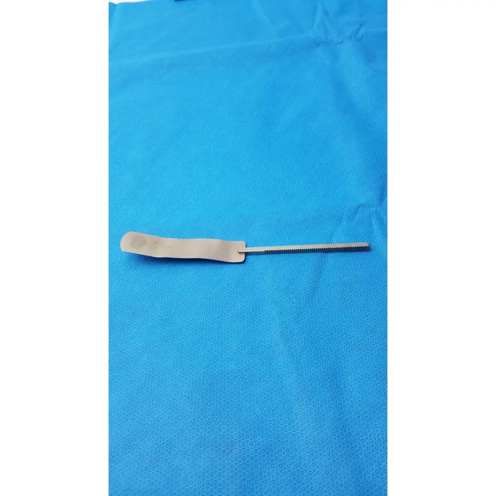 Osteotome stainless steel surgical instrument with a flat rectangular handle and serrated steel surgical blade