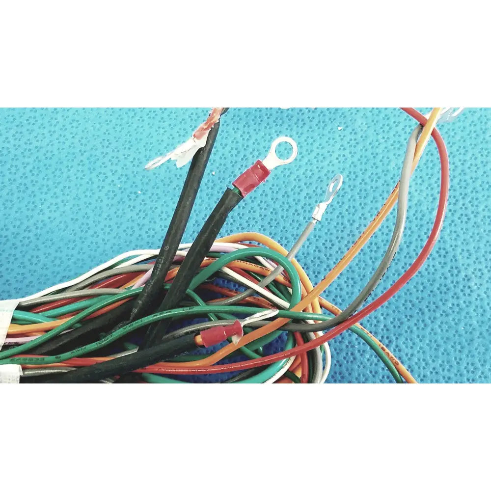 A tangle of multicolored connectors wire harness cable with exposed ends and red and silver ring terminals for P10 103