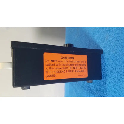Black rectangular Parks Medical Electronics flow detector model 811-B with orange caution label on back side