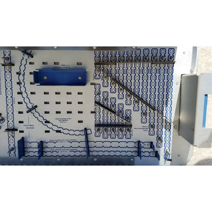 Blue plastic pelvic fragment component with metallic connectors mounted on white circuit board for reuse medical implants