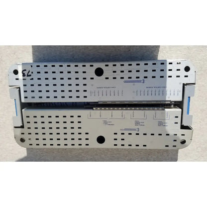Silver metallic pelvic fragment surgical instrument tray with perforated surface and labeled compartments for reuse medical screws