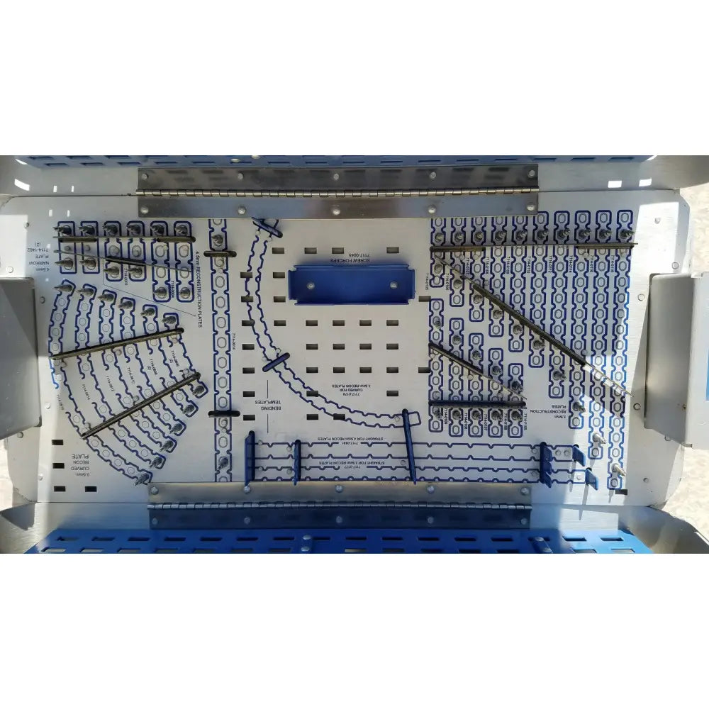 Blue and white metal pelvic fragment system implant tray with labeled compartments for organized reuse medical tools