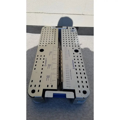 Silver metallic pelvic fragment surgical instrument tray with perforated surface and labeled compartments for reuse medical use