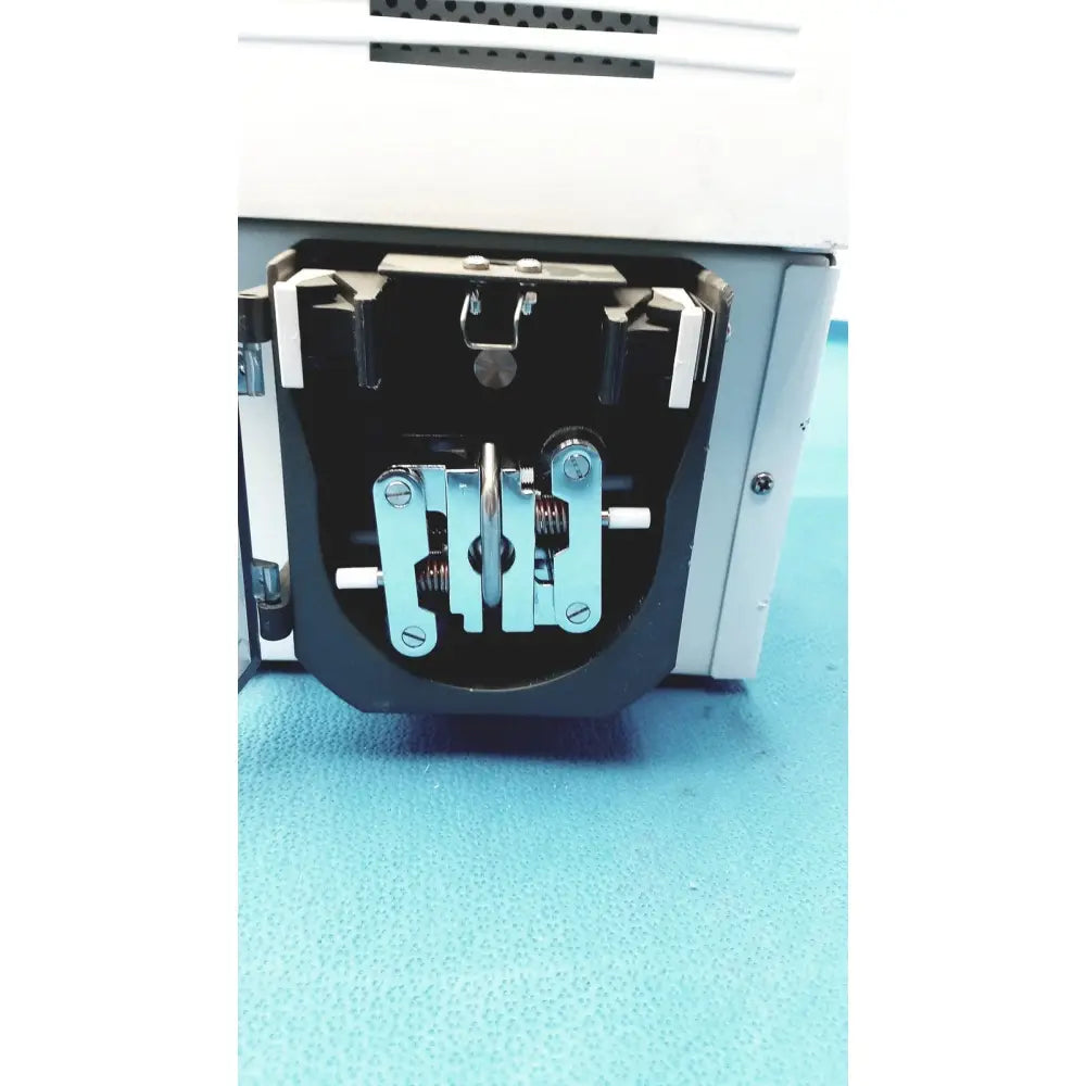 Black and silver mechanical latch mechanism with screws and springs on perkin elmer peri pump cjl8002 janus g3 workstation