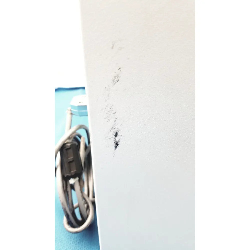 A smudged black mark on a white surface of the perkin elmer peri pump cjl8002 janus g3 workstation component
