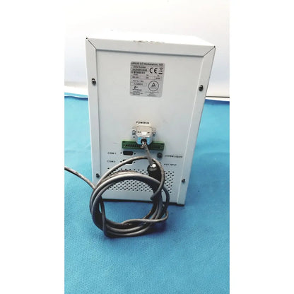 White metal janus q3 workstation ivd enclosure with coiled black cable and labeled ports view of perkin elmer peri pump cjl8002 back side