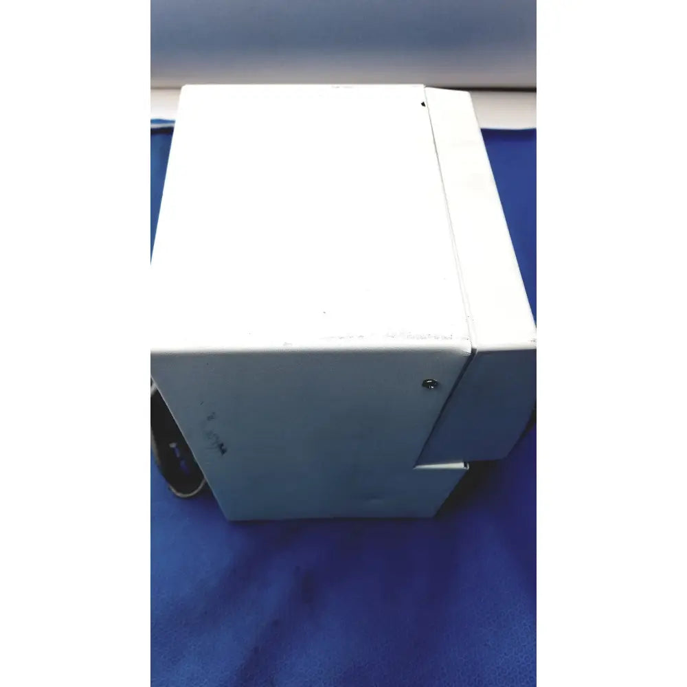 White plastic cash register with worn surface and visible screws for perkin elmer peri pump cjl8002 workstation