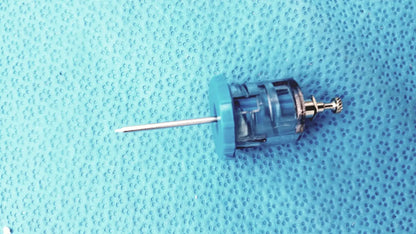 Blue plastic syringe with metallic needle and threaded cap from persys medical nio adult simulation kit
