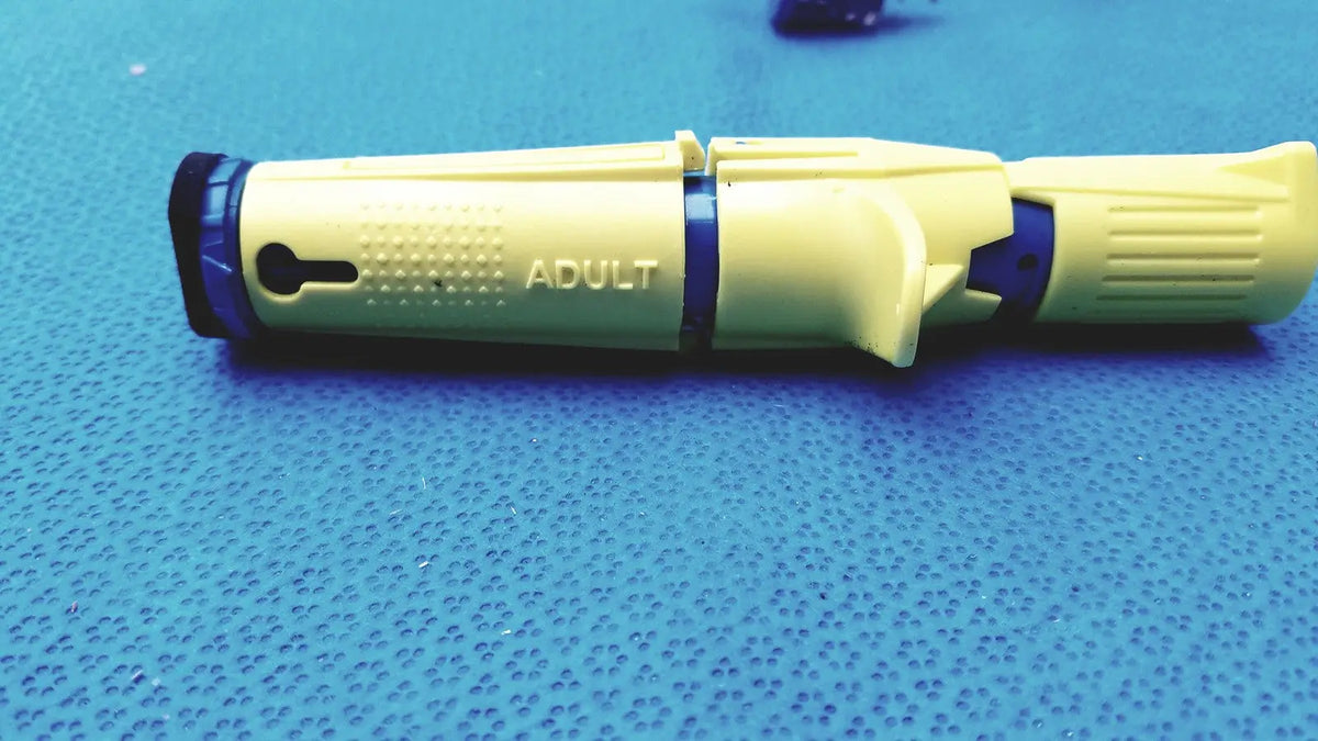 Yellow and blue plastic insulin pen with adult printed on the side for persys medical nio adult simulation kit