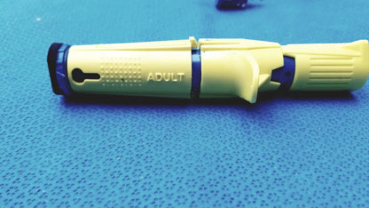 Yellow and blue plastic insulin pen with adult printed on the side for persys medical nio adult simulation kit