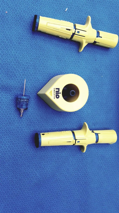 Yellow persys medical nio adult simulation medical injector with black accents and ergonomic grip design