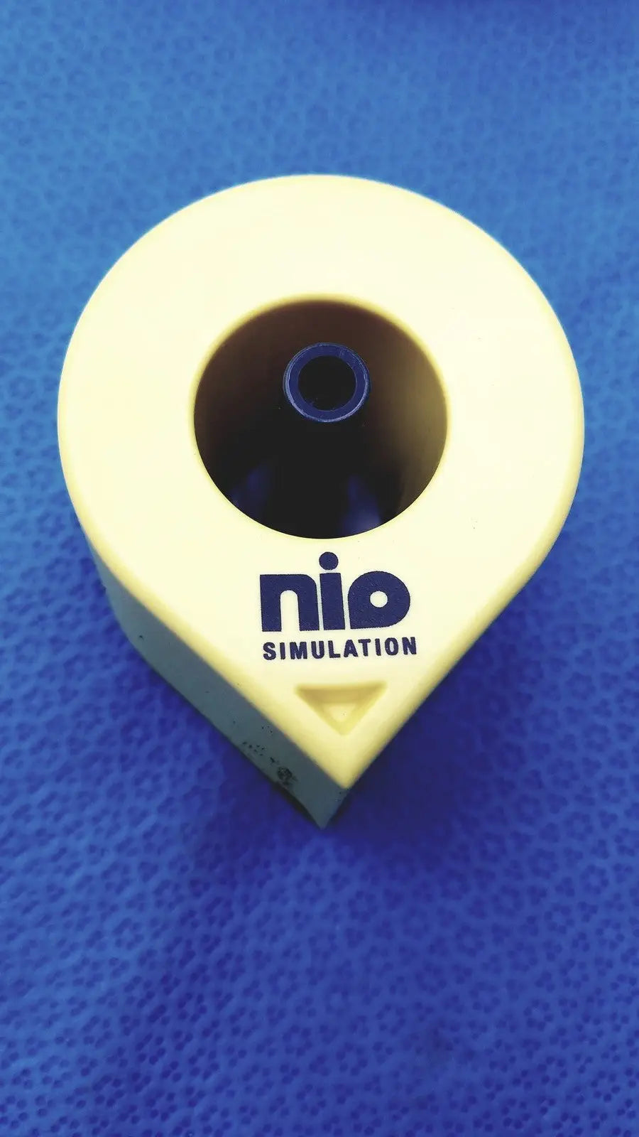 Yellow plastic Persys Medical Nio adult simulation kit device with circular opening and blue inner component for nio adult simulation