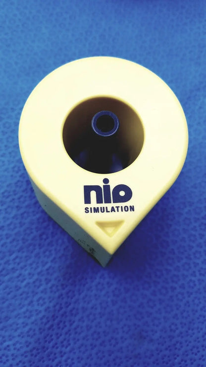 Yellow plastic Persys Medical Nio adult simulation kit device with circular opening and blue inner component for nio adult simulation