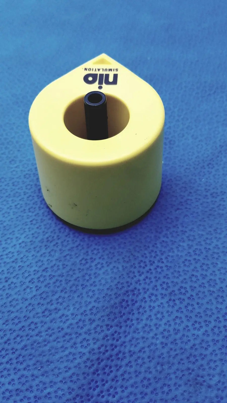 Yellow plastic persys medical nio adult simulation kit with black cylindrical insert for nio adult simulation use