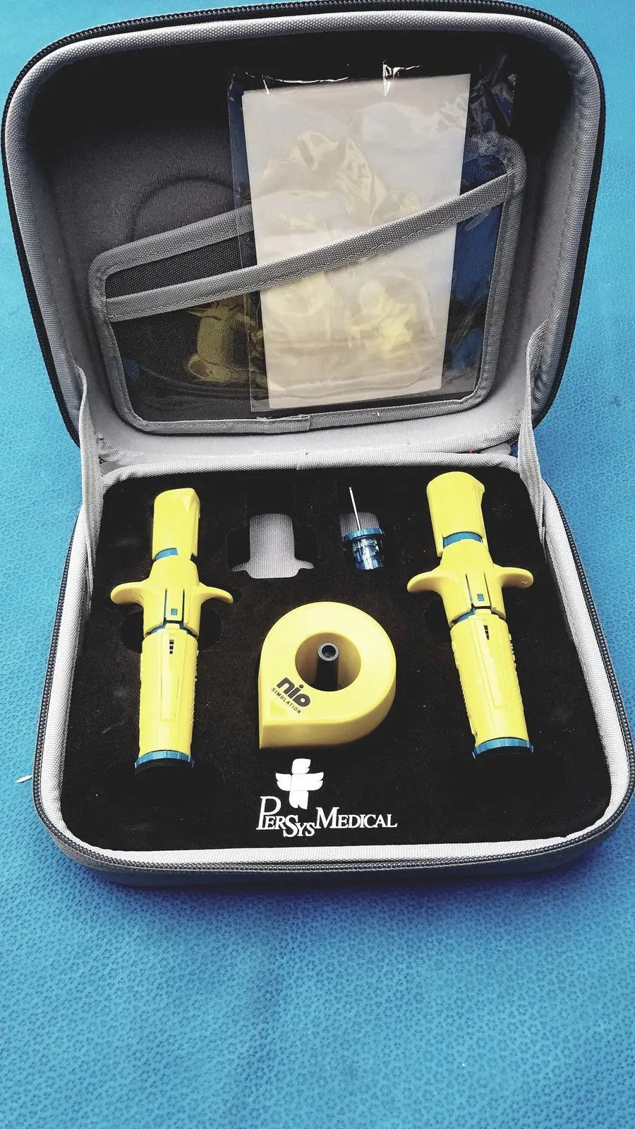 Yellow nio rescue breathing device set in black case for persys medical nio adult simulation kit use