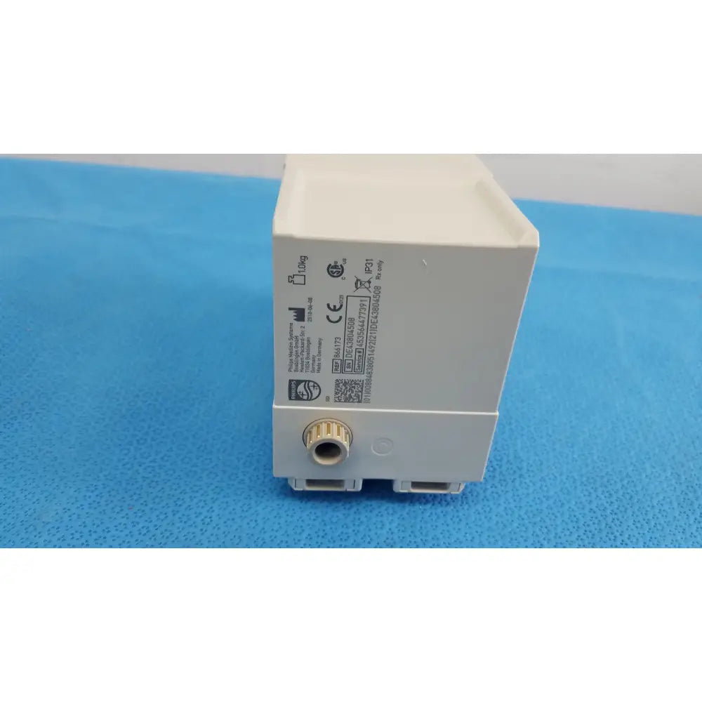 White plastic philips intellivue g7m module electrical outlet with gold threaded connector and certification markings on side