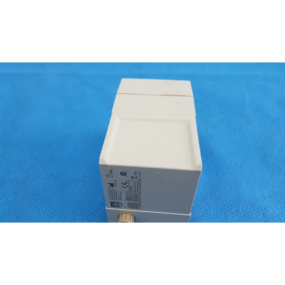 White rectangular philips intellivue g7m module with metallic gold connector and certification labels on its side
