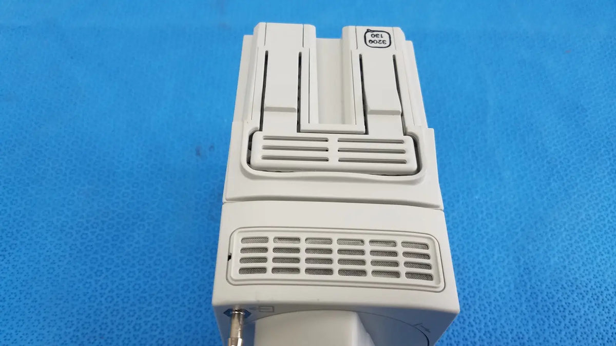 White plastic Dell M100 printer with rectangular design and vented front panel shown alongside Philips IntelliVue G7m module