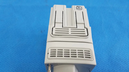 White plastic Dell M100 printer with rectangular design and vented front panel shown alongside Philips IntelliVue G7m module