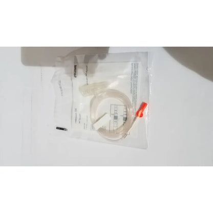 Clear plastic microstream filterline set tubing with bright orange cap in transparent Philips bag for adult and pediatric use