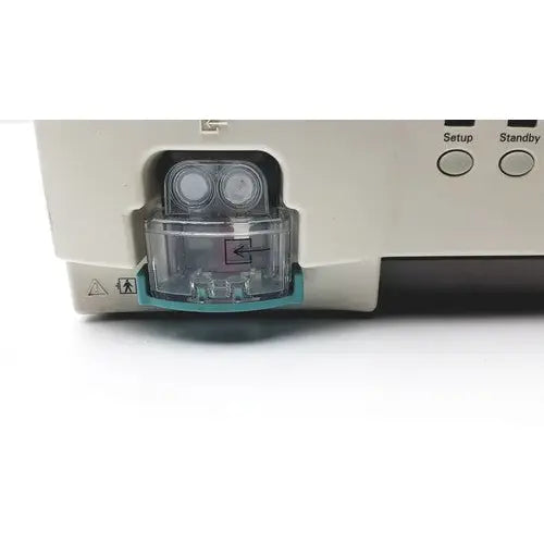 Clear plastic fluid reservoir with teal base integrated into beige philips intellivue g5 m1019a anesthesia gas monitor module