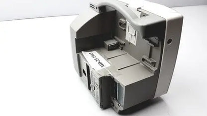 Gray plastic cash register with curved top and multiple compartments shown with philips intellivue m4605a mp30 patient monitor