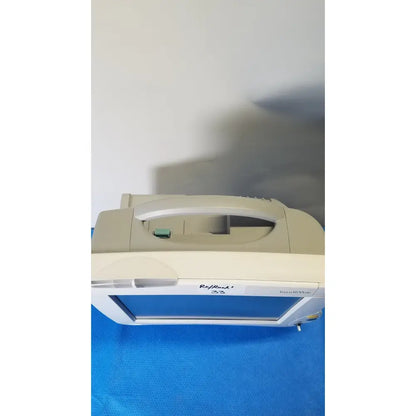 Beige plastic-cased philips intellivue m8105a patient monitor with blue screen and rapid 23 label for medical use