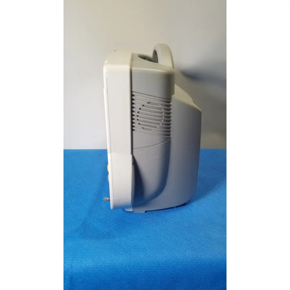 Gray plastic nebulizer with curved handle and vented side panel on the back of philips intellivue m8105a patient monitor