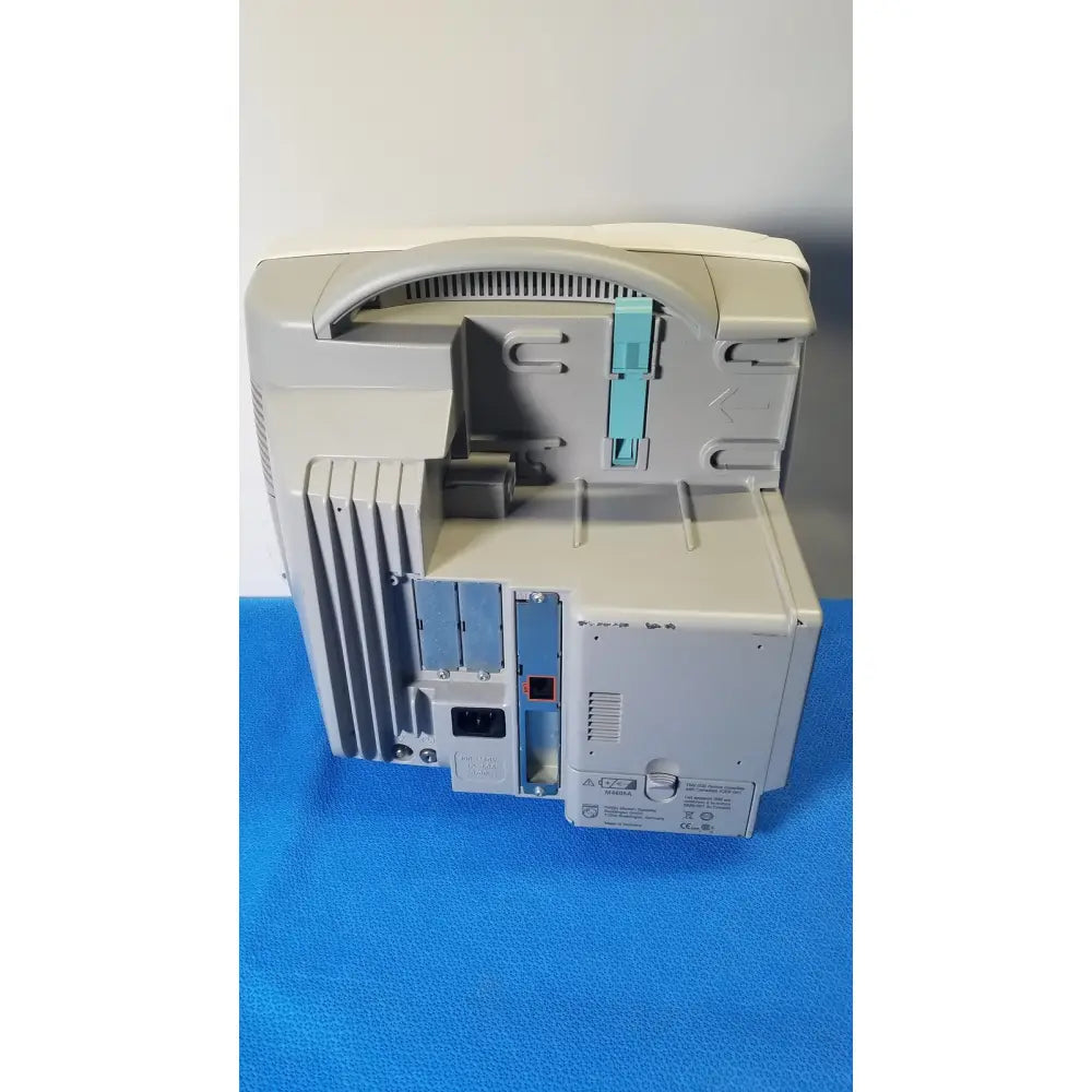 Beige plastic desktop printer with light blue cartridge slot and gray ventilation slats in philips intellivue m8105a patient monitor