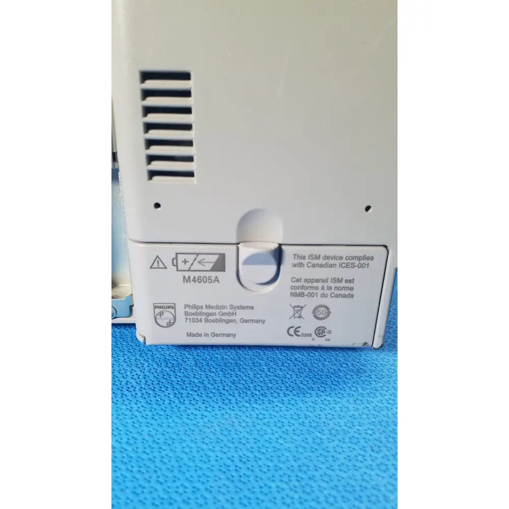 White plastic philips intellivue m8105a patient monitor back with ventilation slits and regulatory labels m8105a device