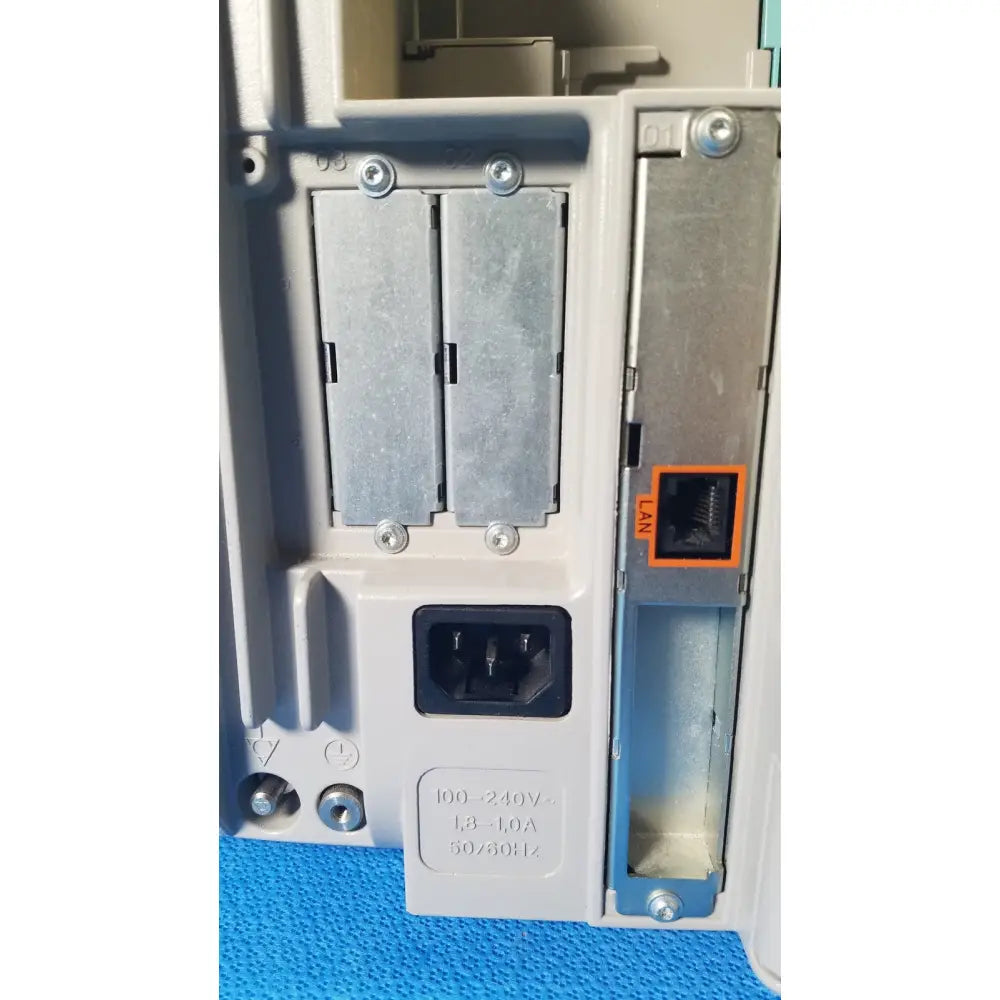 Back side of gray philips intellivue m8105a patient monitor power supply with ac input and ethernet lan ports