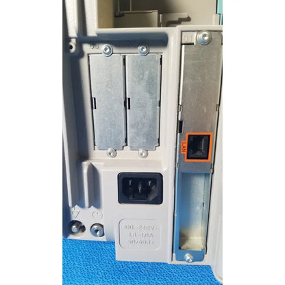 Back side of gray philips intellivue m8105a patient monitor power supply with ac input and ethernet lan ports