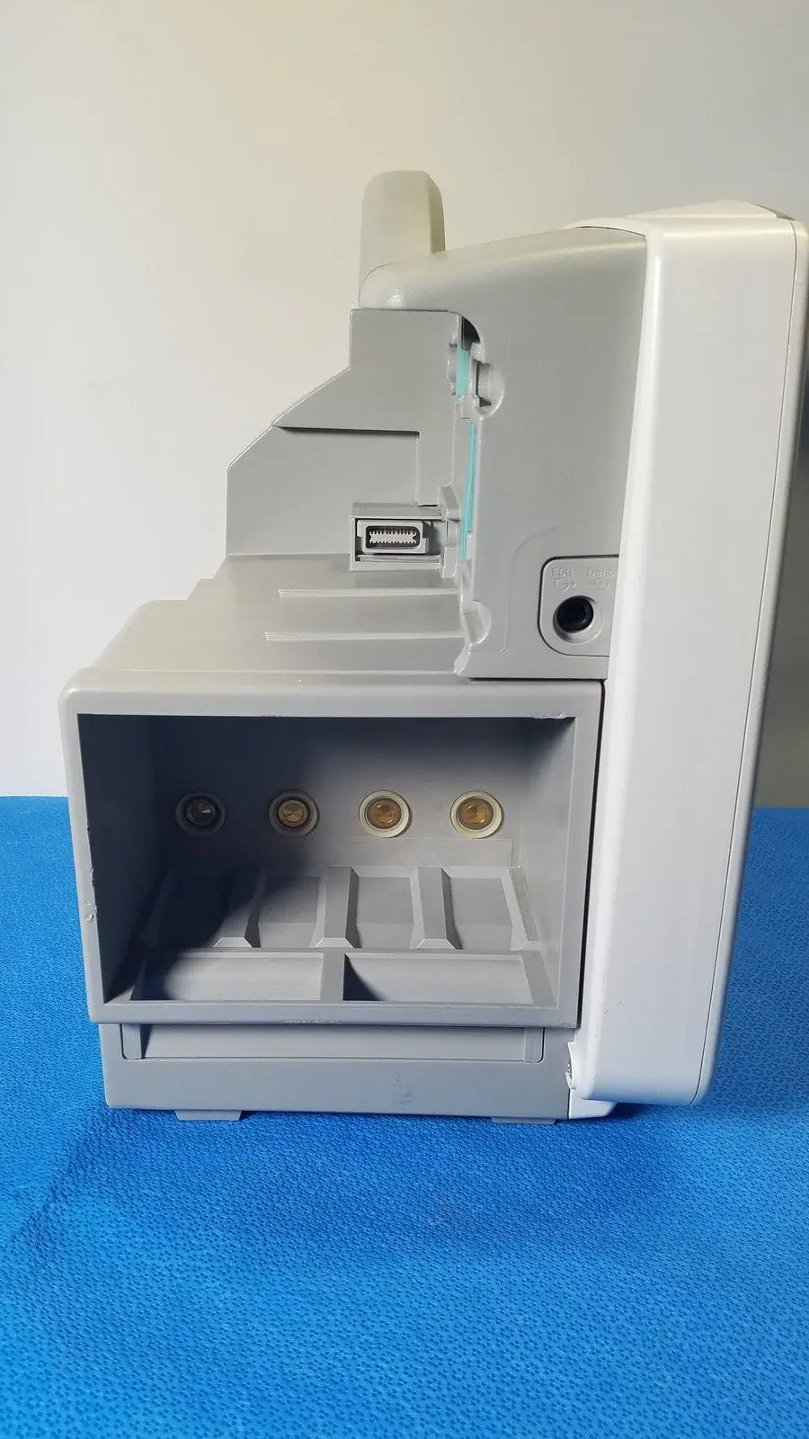 Gray plastic philips intellivue m8105a patient monitor with usb port and three gold circular connectors on front panel