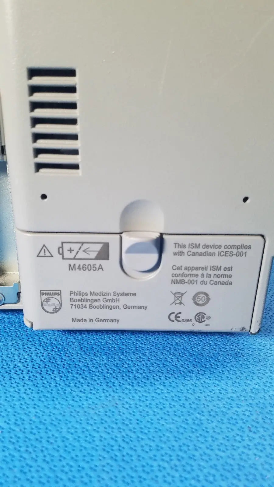 White plastic philips intellivue m8105a patient monitor back with ventilation slits and regulatory labels m8105a device