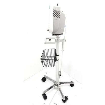 White medical examination lamp mounted on chrome stand with black caster wheels and wire basket for philips intellivue mp30 m4605a