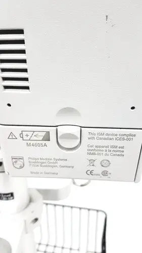 White plastic back panel of philips intellivue mp30 m4605a with regulatory labels on the mp30 m4605a stand device