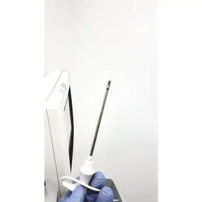 A white medical needle with black shaft and metallic tip held in gloved hands for philips intellivue mp5t patient use