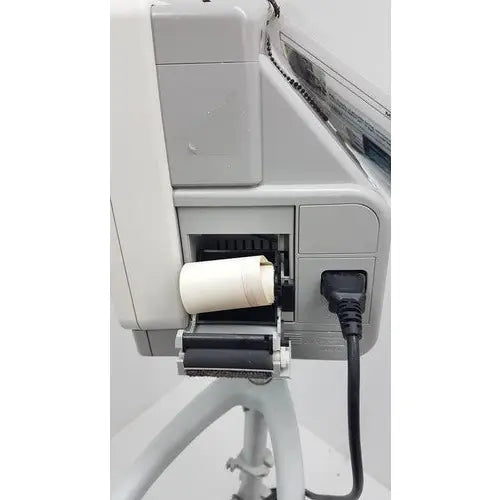 White cylindrical paper roll loaded into gray industrial printer on philips intellivue mp5t patient monitor rolling stand