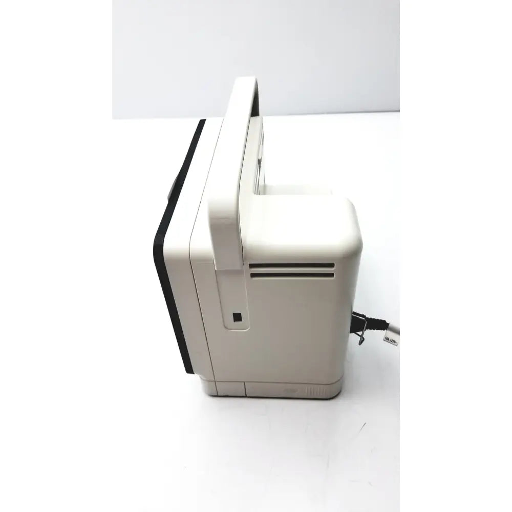 Beige plastic nintendo entertainment system console with black trim and handle shown with philips intellivue mx400 patient monitor