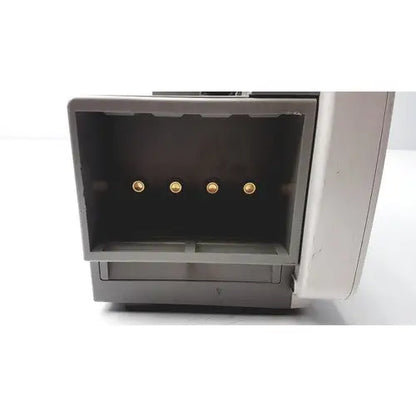 Gray plastic philips intellivue patient monitor with four gold circular connectors visible inside open back compartment