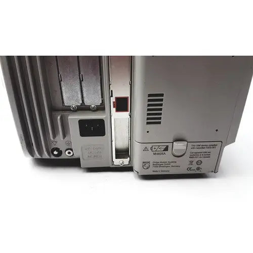 Gray metal philips intellivue patient monitor back side with ventilation slots and power input port for medical use