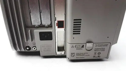 Gray metal philips intellivue patient monitor back side with ventilation slots and power input port for medical use