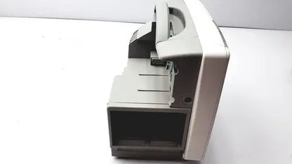 Gray plastic cash counting machine with black display and metallic accents featured alongside philips intellivue patient monitor