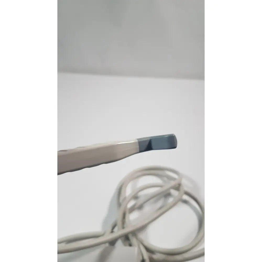 A beige and gray philips l15-7io linear array ultrasound transducer probe with a smooth plastic body