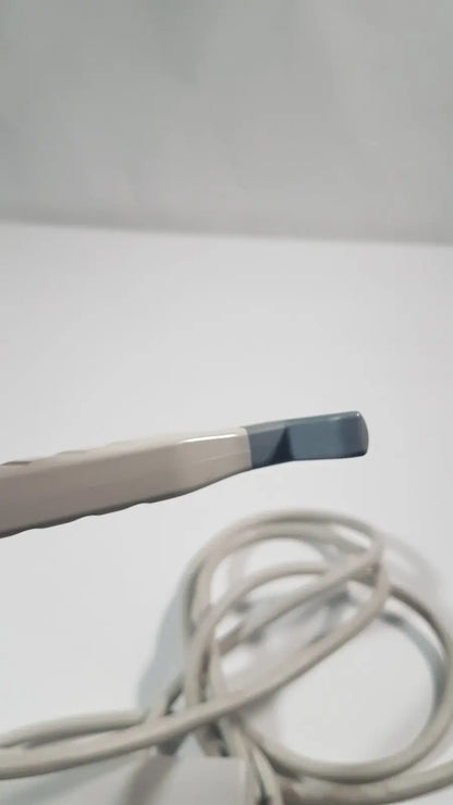 A beige and gray philips l15-7io linear array ultrasound transducer probe with a smooth plastic body