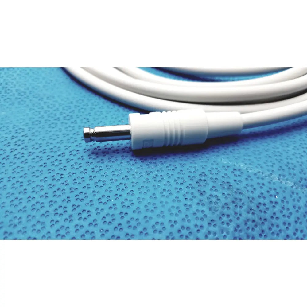 White medical-grade air hose m1599b adult with metallic 3.5mm audio jack coiled on blue perforated surface